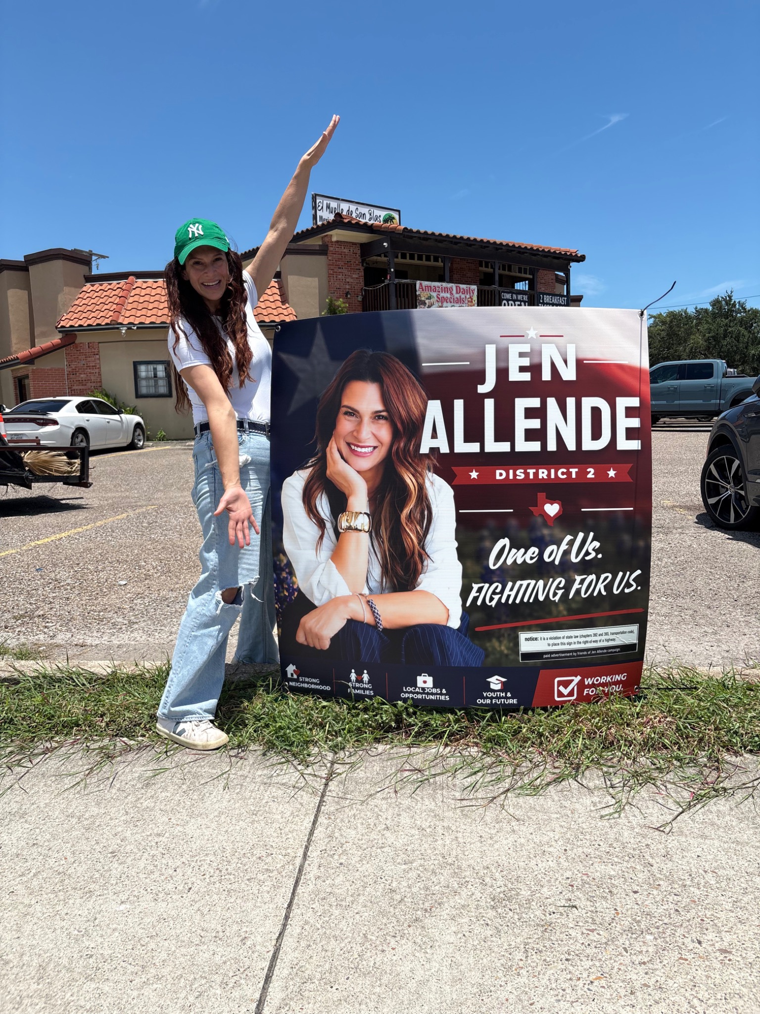 Jen Allende placing a District 2 campaign yard sign